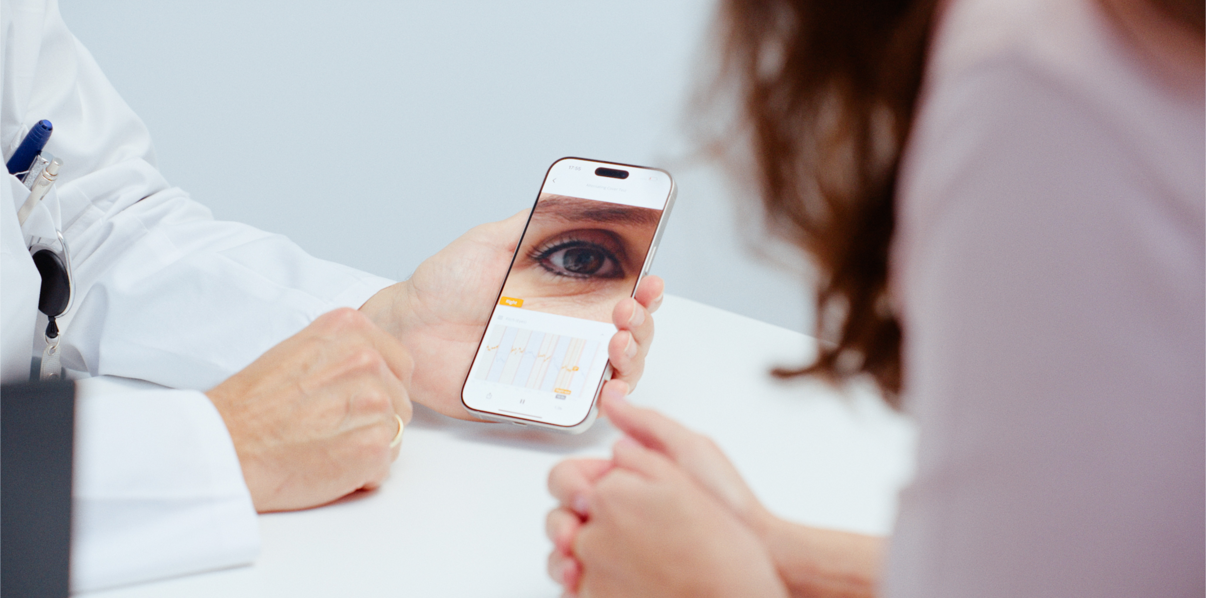 Doctor reviewing VertifyMed exam results with a patient at the desk